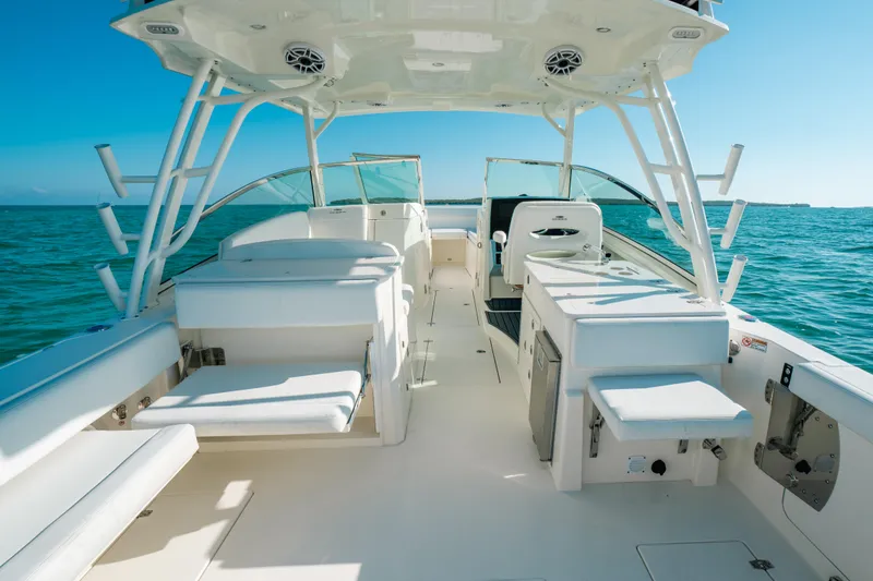 Slide: The Image of 2024 Cobia 330 Dual Console boat interior with seating and ocean view. - 6