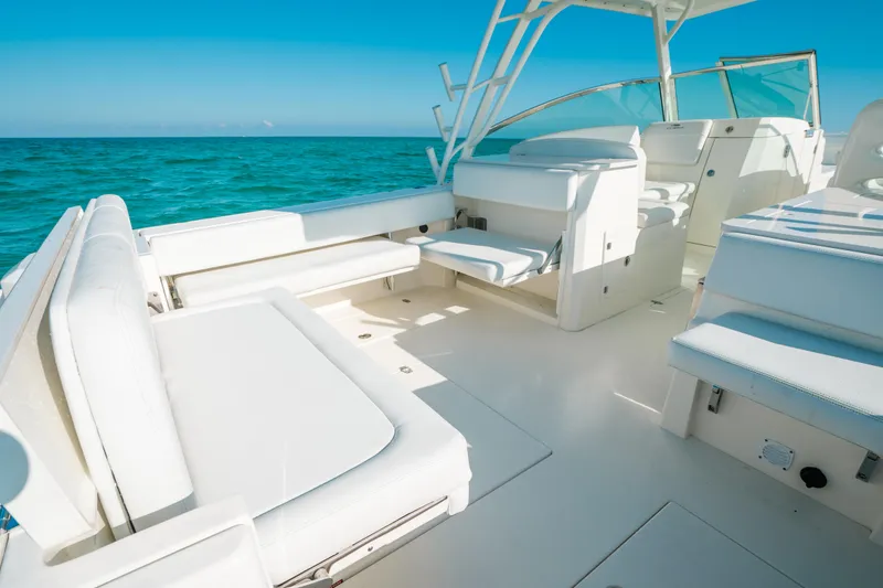 Slide: The Image of 2024 Cobia 330 Dual Console boat interior with white seating, ocean view. - 7
