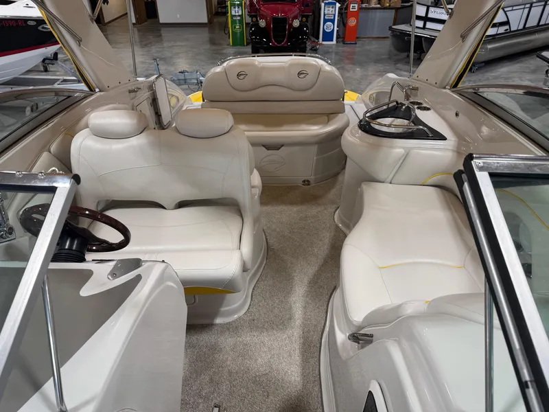 Slide: The Image of 2007 Crownline 320LS boat interior with white leather seating and modern dashboard. - 10