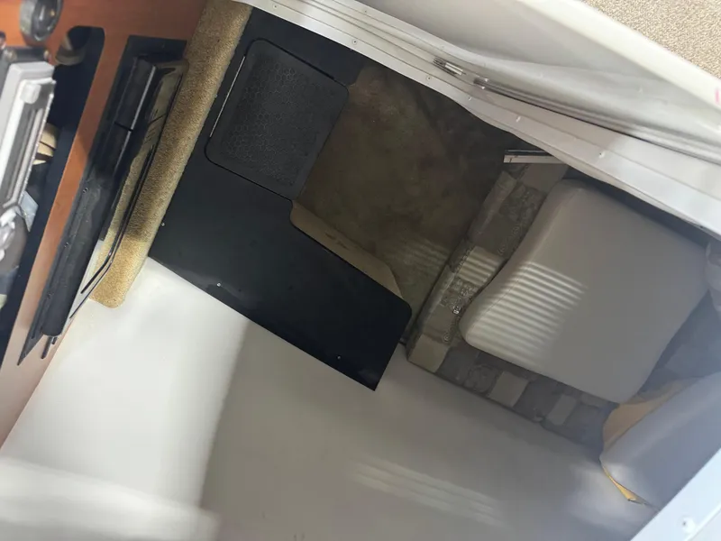 Slide: The Image of Interior view of a 2007 Crownline 320LS boat cabin with seating and storage. - 12