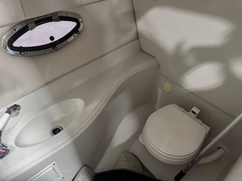 Slide: The Image of 2007 Crownline 320LS boat bathroom with sink and toilet. - 14