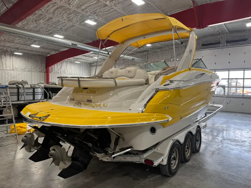 Slide: The Image of 2007 Crownline 320LS boat with yellow accents in a warehouse setting. - 4