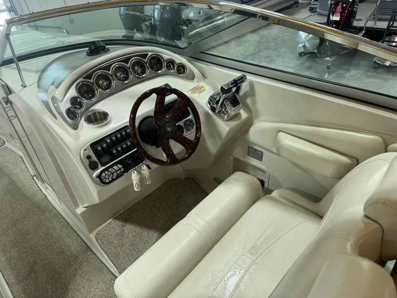 Slide: The Image of 2007 Crownline 320LS boat cockpit with steering wheel and control panel. - 7