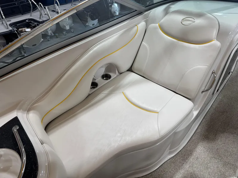Slide: The Image of 2007 Crownline 320LS boat interior with white leather seating and yellow accents. - 8