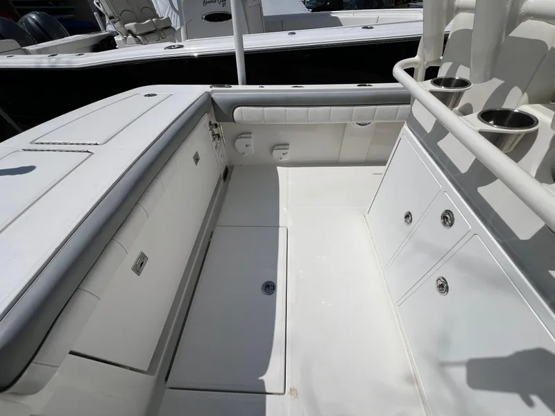 Slide: The Image of 2019 Regulator 28 boat interior with storage compartments and cup holders. - 10