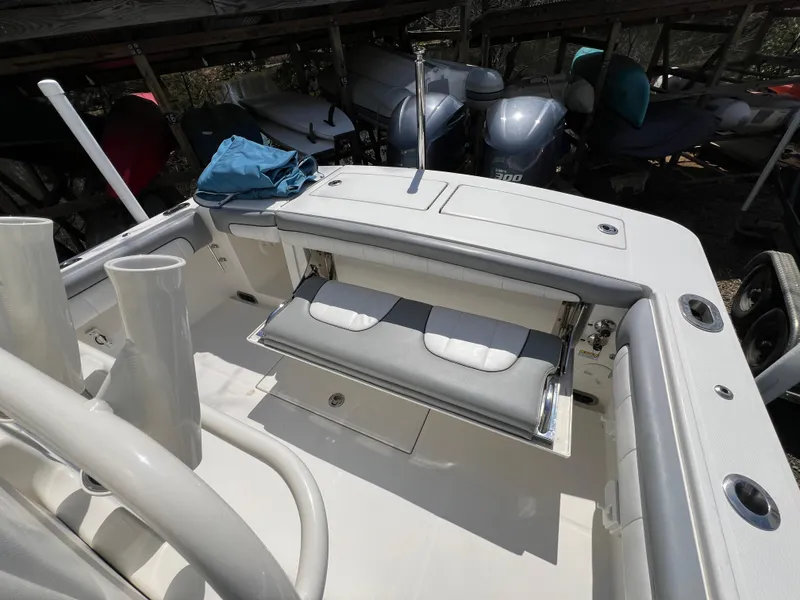 Slide: The Image of 2019 Regulator 28 boat interior with foldable seating and storage compartments. - 12