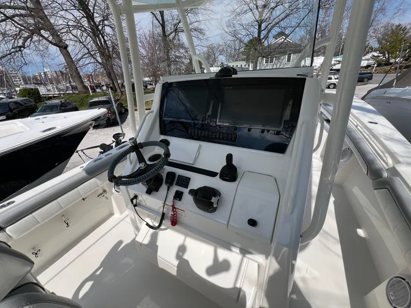 Slide: The Image of 2019 Regulator 28 boat cockpit with steering wheel and control panel. - 15