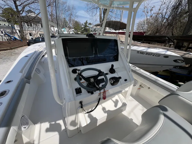 Slide: The Image of 2019 Regulator 28 boat cockpit with steering wheel and control panel. - 16