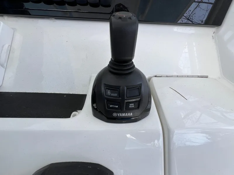 Slide: The Image of Yamaha joystick control on 2019 Regulator 28 boat dashboard. - 18