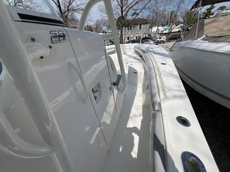 Slide: The Image of 2019 Regulator 28 boat deck, white interior, outdoor setting, trees in background. - 21