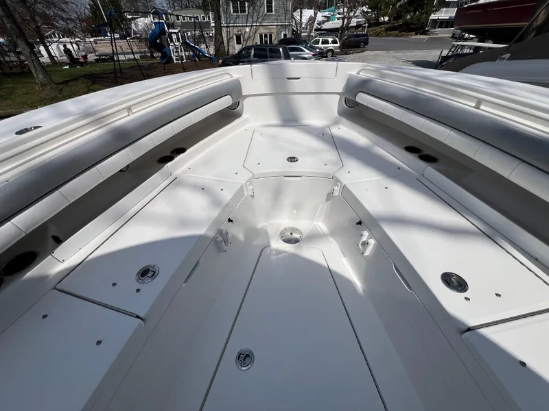 Slide: The Image of 2019 Regulator 28 boat interior with spacious seating and storage compartments. - 25