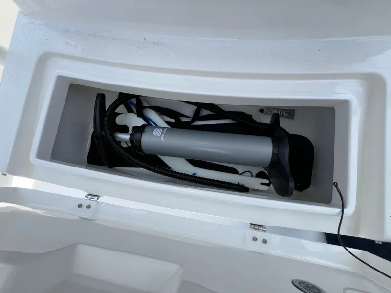 Slide: The Image of Storage compartment on a 2019 Regulator 28 boat with pump and accessories. - 31