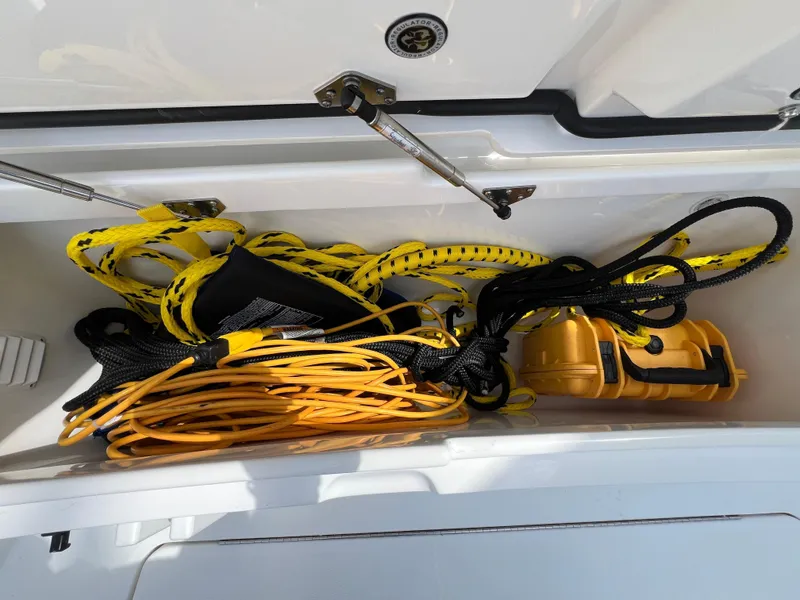 Slide: The Image of Storage compartment on a 2019 Regulator 28 boat with ropes and equipment. - 34