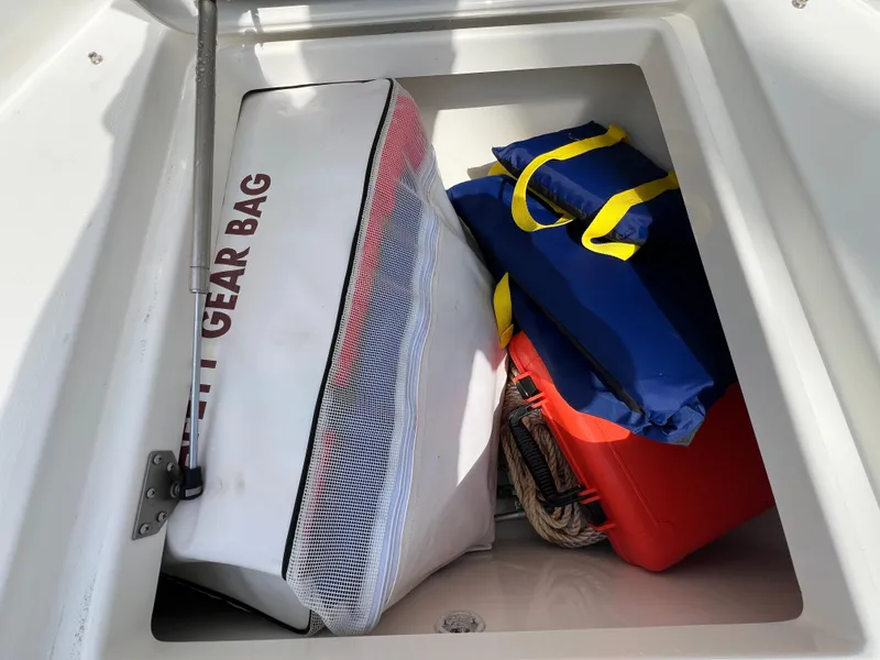Slide: The Image of Storage compartment on a 2019 Regulator 28 boat with gear bags and equipment. - 35