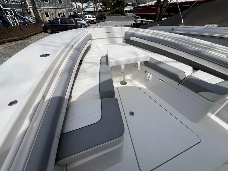 Slide: The Image of 2019 Regulator 28 boat interior with cushioned seating and table. - 37