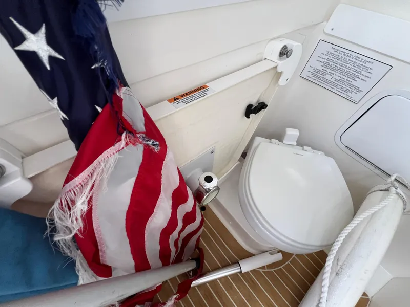 Slide: The Image of 2019 Regulator 28 boat bathroom with American flag and toilet. - 39