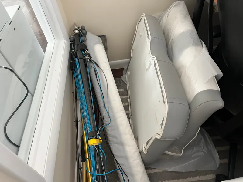 Slide: The Image of Stored boat cushions and fishing rods beside a window, Regulator 28, 2019 model. - 43