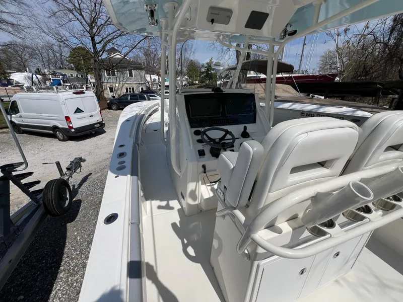 Slide: The Image of 2019 Regulator 28 boat interior with helm, seats, and rod holders. - 8