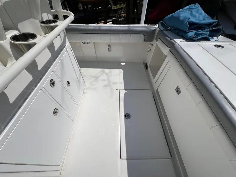 Slide: The Image of 2019 Regulator 28 boat interior with storage compartments and cup holders. - 9