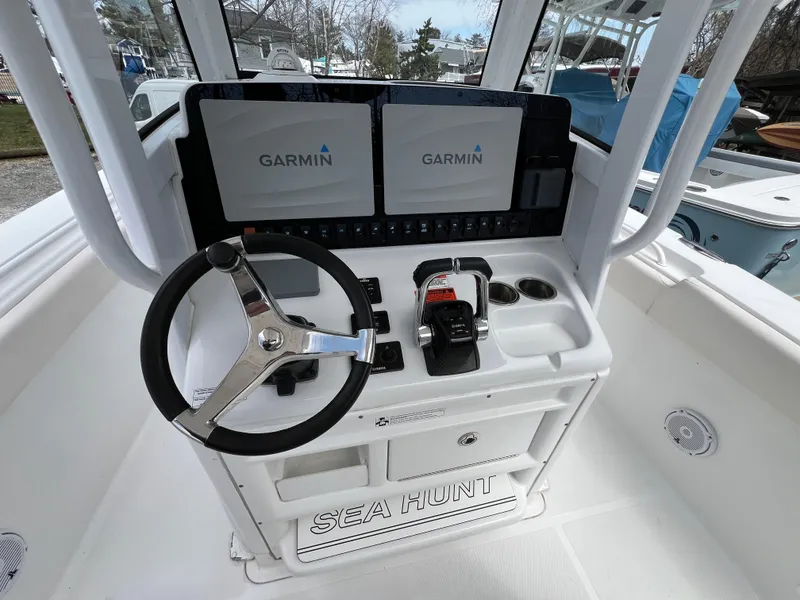 Slide: The Image of 2020 Sea Hunt Gamefish 27 console with Garmin displays and steering wheel. - 14