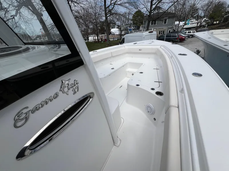 Slide: The Image of 2020 Sea Hunt Gamefish 27 boat with forward seating, docked outdoors. - 19