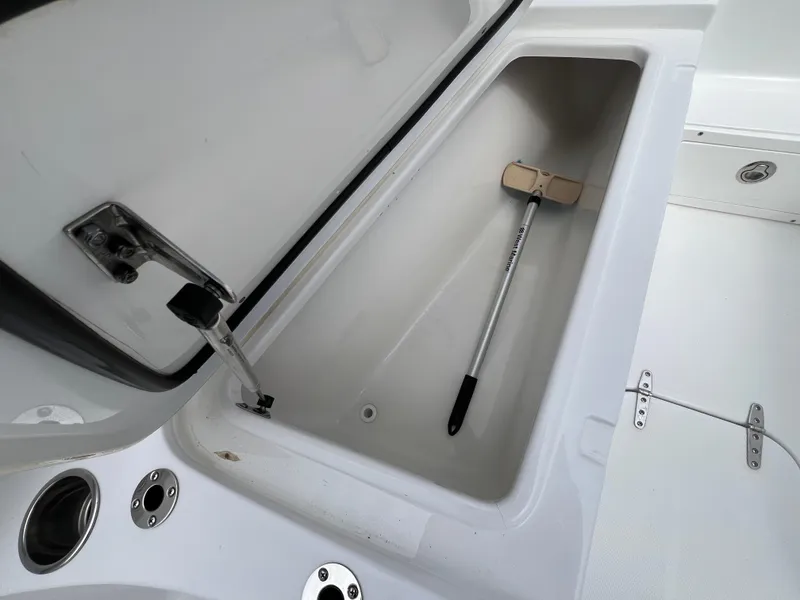 Slide: The Image of 2020 Sea Hunt Gamefish 27 storage compartment with cleaning tool inside. - 22