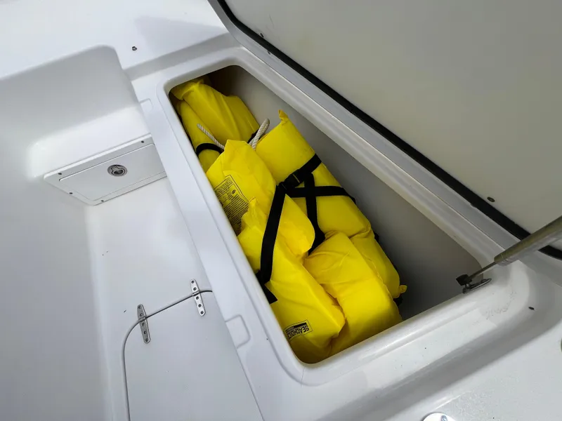 Slide: The Image of Yellow life jackets stored in a compartment on a 2020 Sea Hunt Gamefish 27 boat. - 23