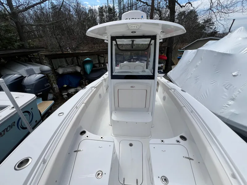 Slide: The Image of 2020 Sea Hunt Gamefish 27 Forward Seating boat, white interior, docked outdoors. - 26