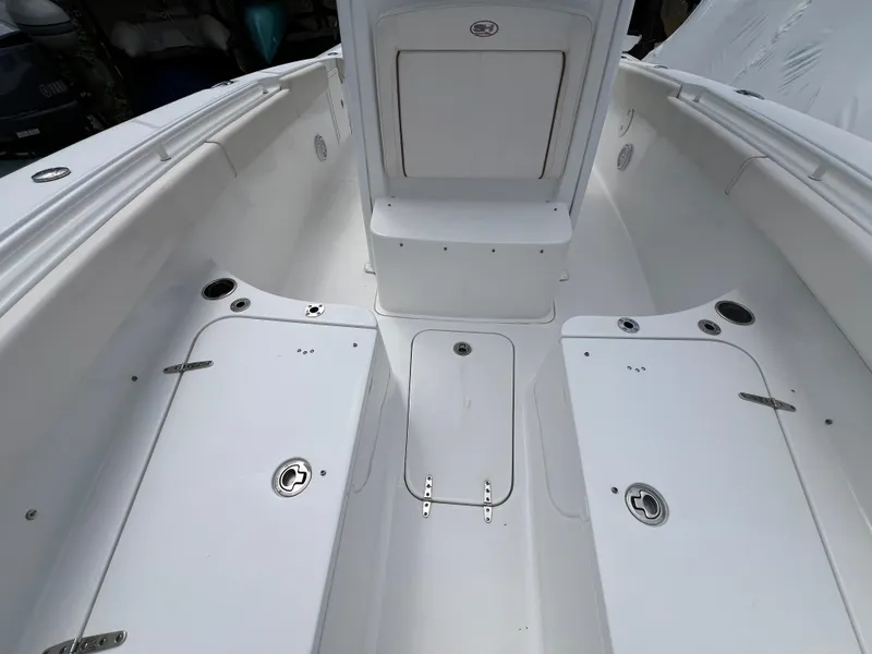 Slide: The Image of 2020 Sea Hunt Gamefish 27 Forward Seating boat interior, featuring spacious white deck and storage compartments. - 28