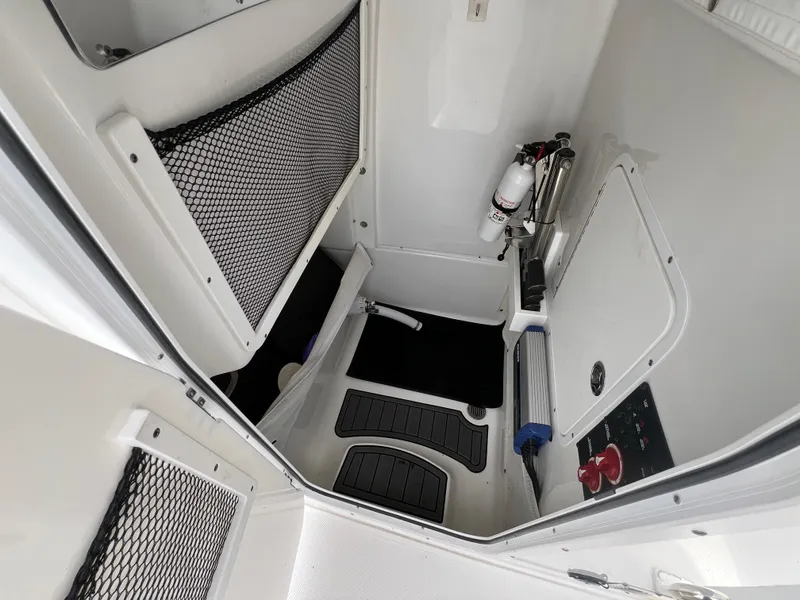 Slide: The Image of 2020 Sea Hunt Gamefish 27 interior storage with safety equipment and netted compartments. - 29