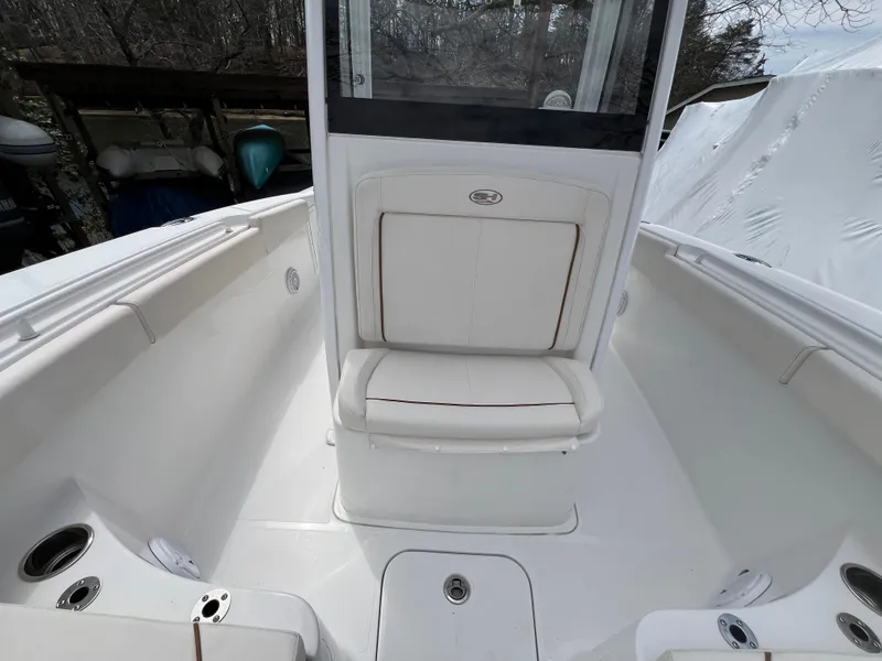 Slide: The Image of 2020 Sea Hunt Gamefish 27 Forward Seating boat interior with white cushioned seats. - 31