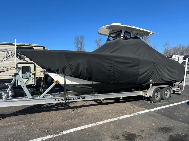 Slide: The Image of 2020 Sea Hunt Gamefish 27 boat covered on trailer in parking lot. - 37