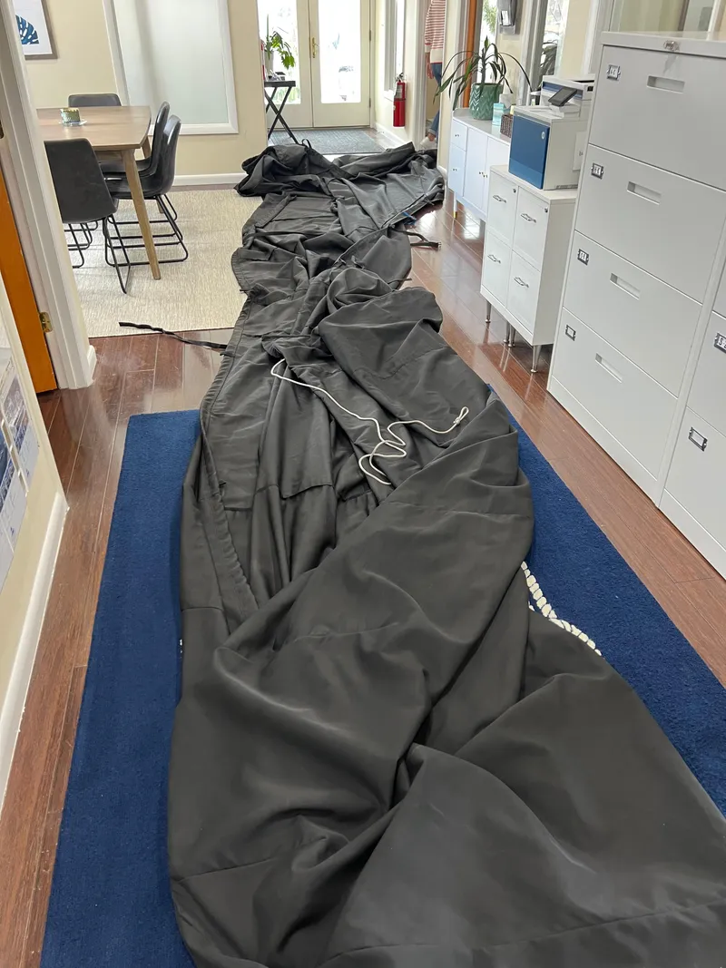 Slide: The Image of Black boat cover for 2020 Sea Hunt Gamefish 27, spread indoors on wooden floor. - 38