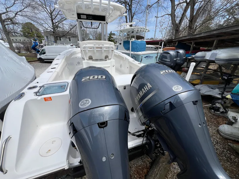 Slide: The Image of 2020 Sea Hunt Gamefish 27 with dual Yamaha 200 engines, parked outdoors. - 6