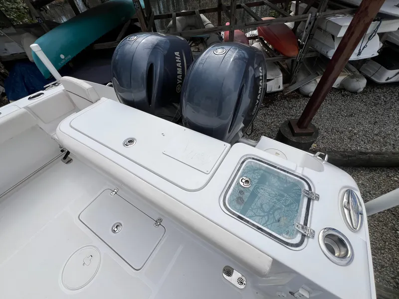 Slide: The Image of 2020 Sea Hunt Gamefish 27 boat with Yamaha engines, featuring forward seating and storage compartments. - 7