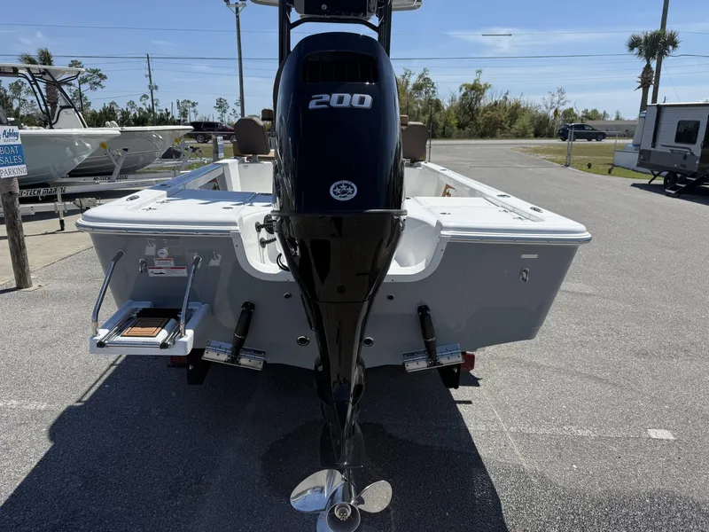 Slide: The Image of 2025 Sea Pro 230 Bay boat with powerful 200 HP engine, parked outdoors. - 4