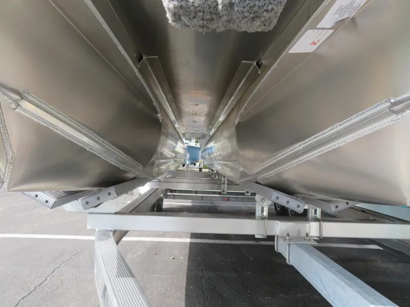 Slide: The Image of Underneath view of 2025 Avalon LSZ Quad Lounger pontoon boat on trailer. - 12