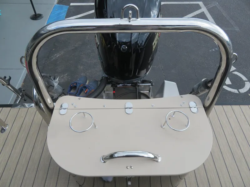 Slide: The Image of 2025 Avalon LSZ Quad Lounger boat with motor and rear deck view. - 17