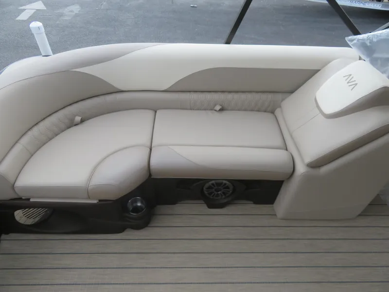Slide: The Image of 2025 Avalon LSZ Quad Lounger boat seating with beige upholstery and integrated cup holders. - 24