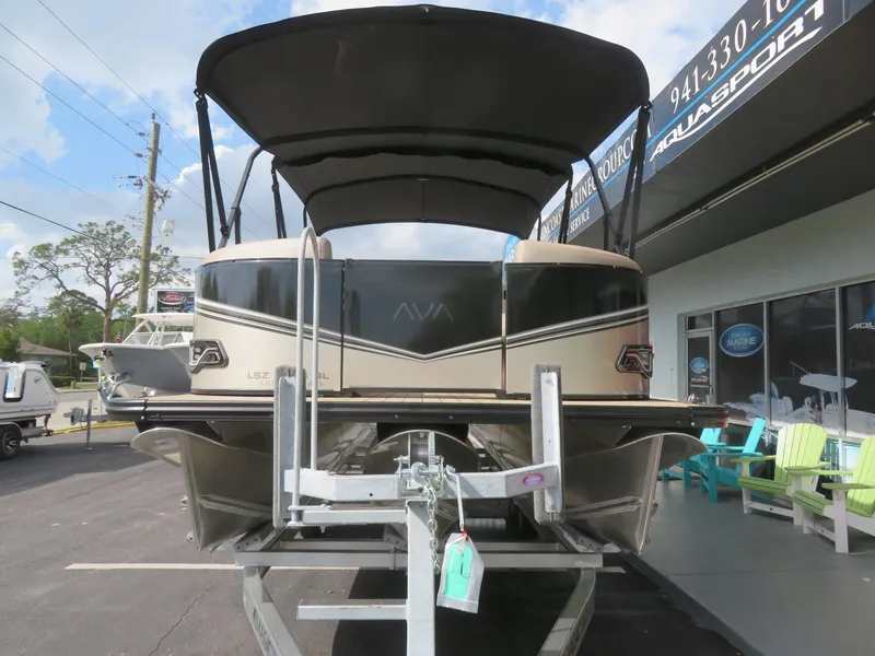 Slide: The Image of 2025 Avalon LSZ Quad Lounger pontoon boat on display at dealership. - 3