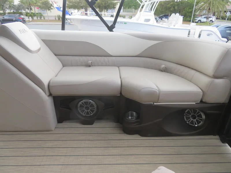 Slide: The Image of 2025 Avalon LSZ Quad Lounger boat interior with beige seating and built-in speakers. - 31