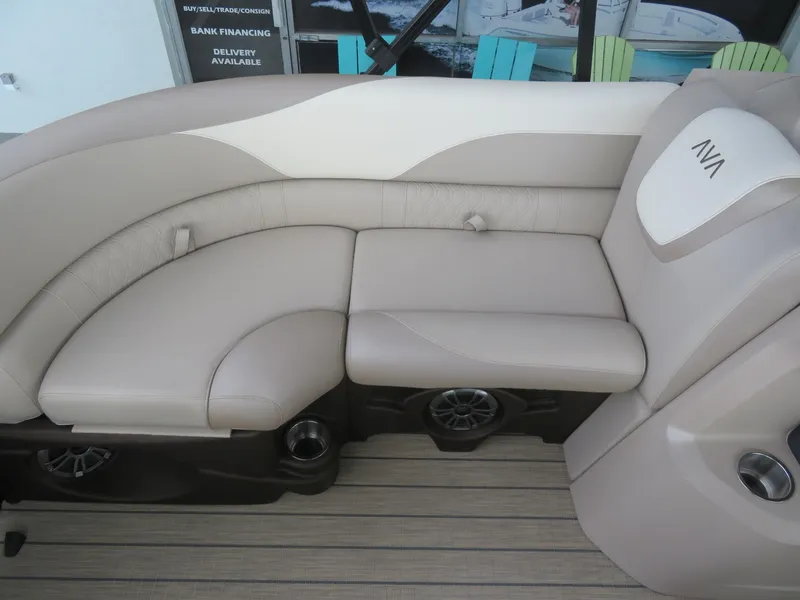 Slide: The Image of 2025 Avalon LSZ Quad Lounger boat seating, beige upholstery, cup holders, and speaker system. - 32
