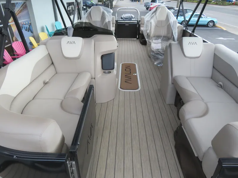 Slide: The Image of 2025 Avalon LSZ Quad Lounger boat interior with beige seating and wood-style flooring. - 35