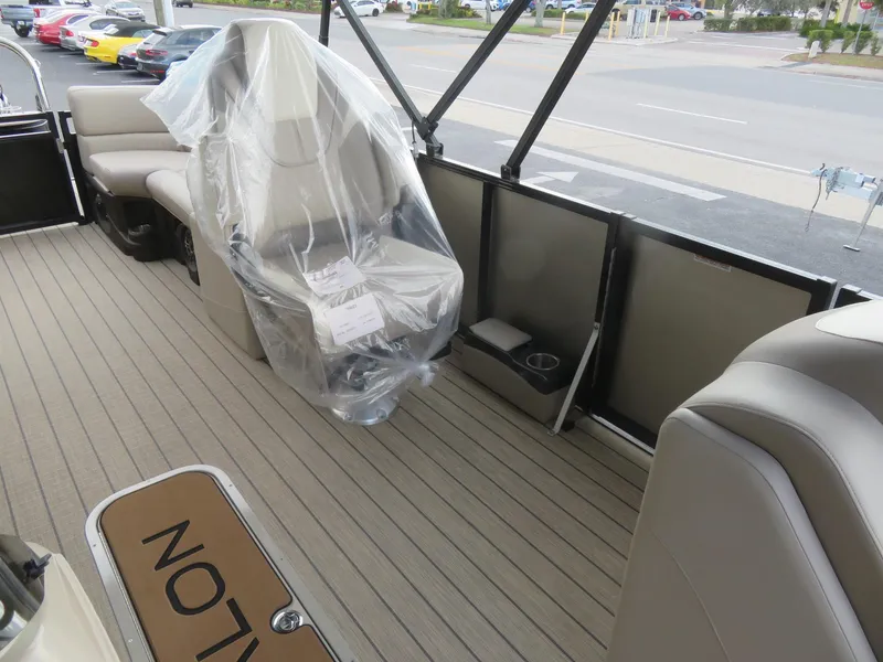Slide: The Image of 2025 Avalon LSZ Quad Lounger interior with beige seating and protective plastic cover. - 37