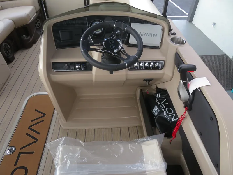 Slide: The Image of 2025 Avalon LSZ Quad Lounger helm with Garmin navigation system and modern controls. - 39