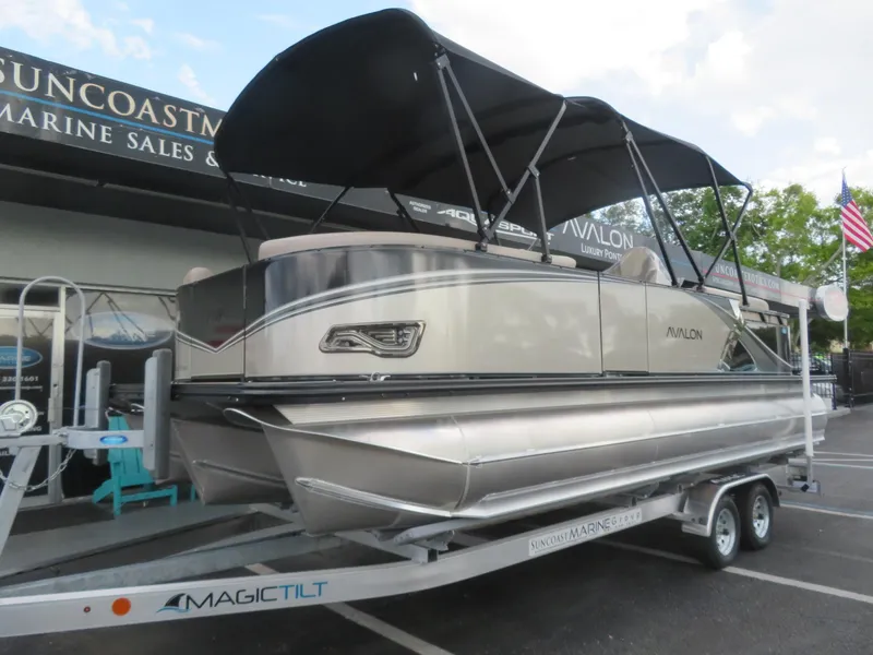 Slide: The Image of 2025 Avalon LSZ Quad Lounger pontoon boat on trailer at marine sales. - 4