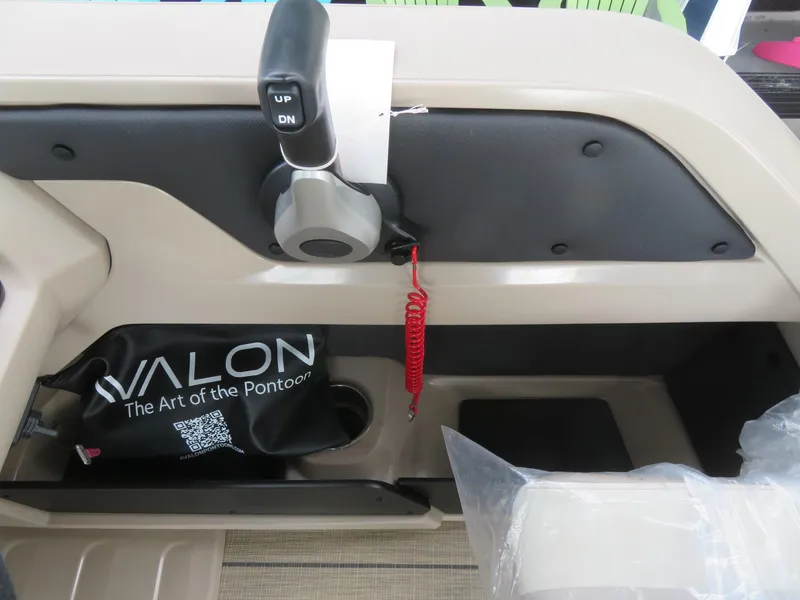 Slide: The Image of 2025 Avalon LSZ Quad Lounger control panel with throttle and branded pouch. - 40