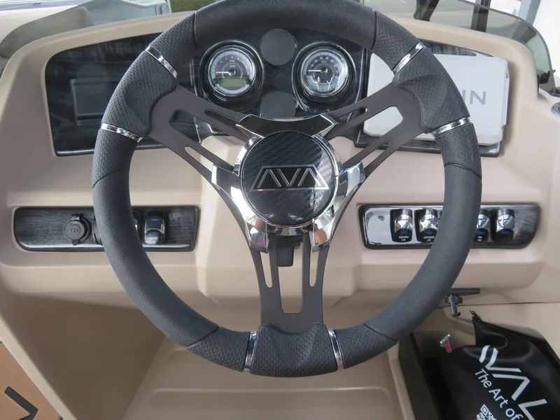 Slide: The Image of Steering wheel of 2025 Avalon LSZ Quad Lounger boat with dashboard controls. - 41