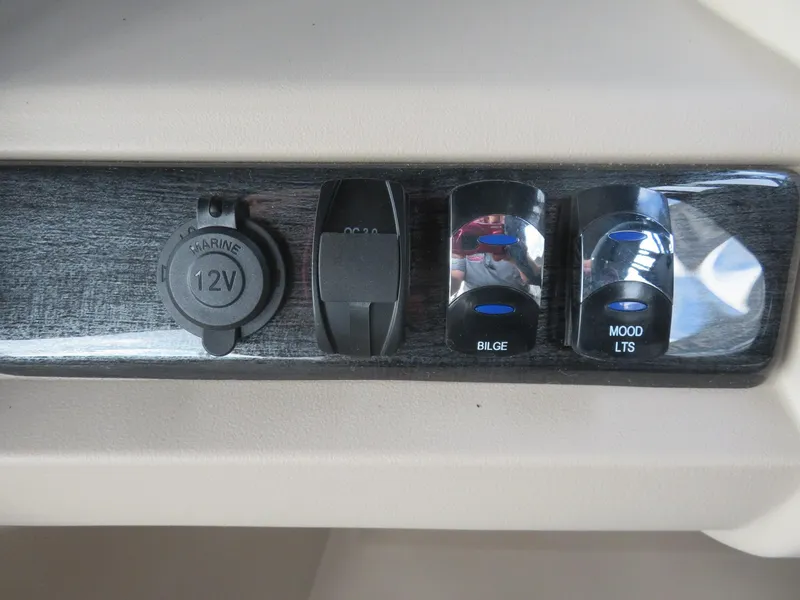 Slide: The Image of Control panel of 2025 Avalon LSZ Quad Lounger with 12V outlet, bilge, and mood lights switches. - 45