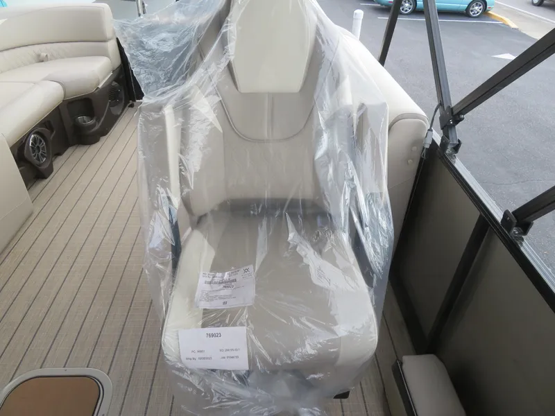 Slide: The Image of 2025 Avalon LSZ Quad Lounger seat wrapped in protective plastic on a boat deck. - 47